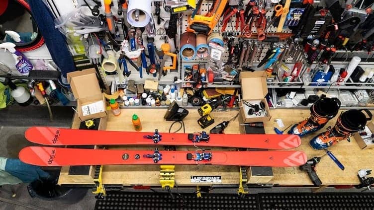 Close-up of ski boots clipping into ski bindings
