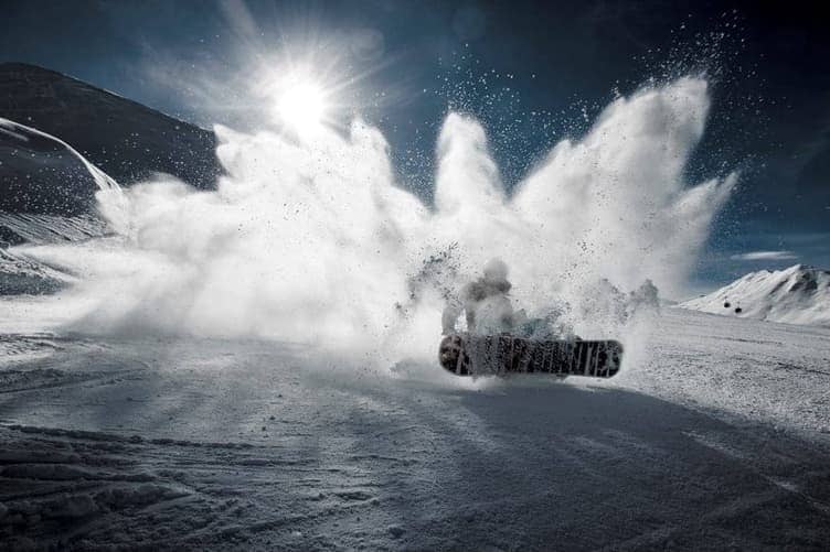 Beginner snowboarder on flat terrain practicing stance