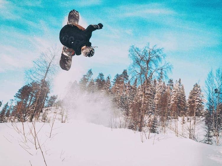 Snowboarder making a turn on a snowy slope