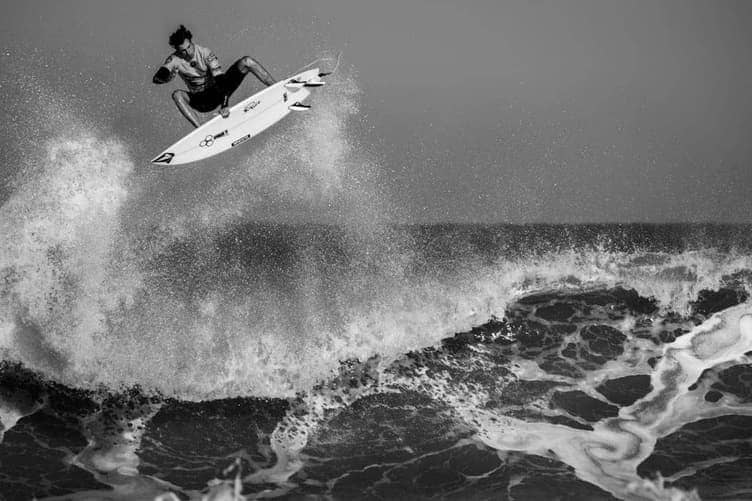 Surfer wiping out in small whitewash waves near shore