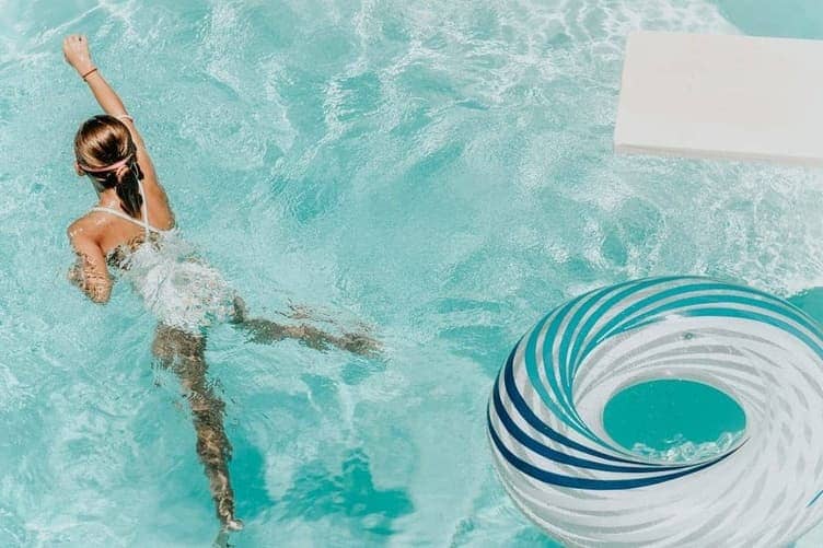 Person floating on their back in a swimming pool