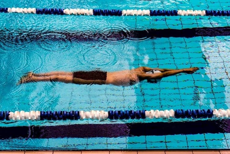 Swimmer doing freestyle stroke in a pool lane
